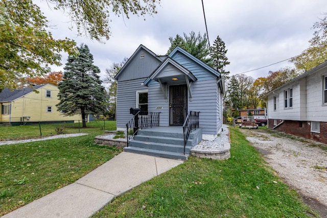 bungalow-style home with a front yard