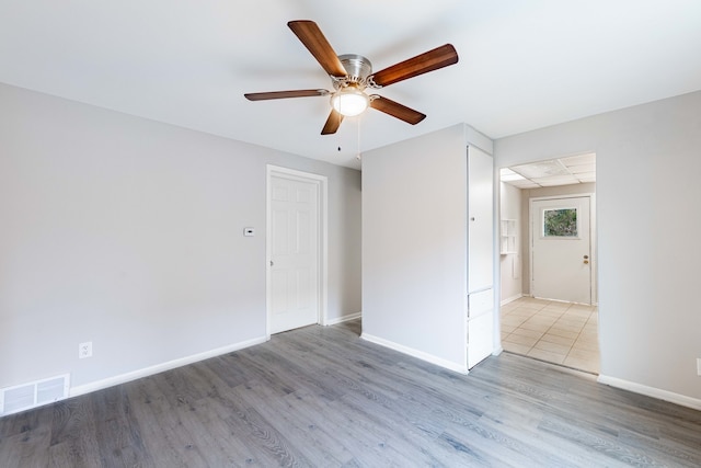 empty room featuring ceiling fan and light hardwood / wood-style flooring