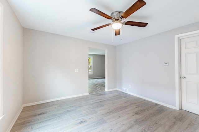 spare room featuring light wood-type flooring and ceiling fan