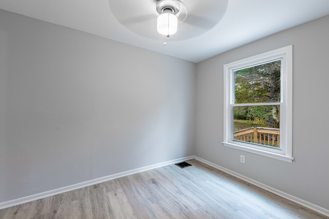 spare room with ceiling fan and light wood-type flooring