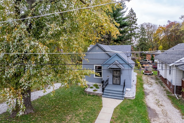 bungalow-style home with a front yard