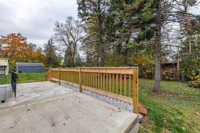 wooden terrace featuring a lawn