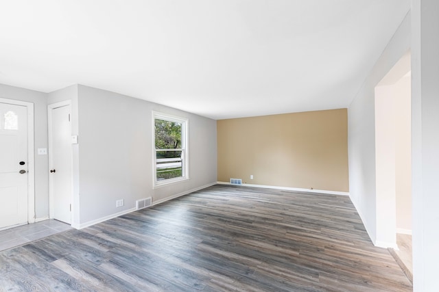 spare room featuring dark hardwood / wood-style floors