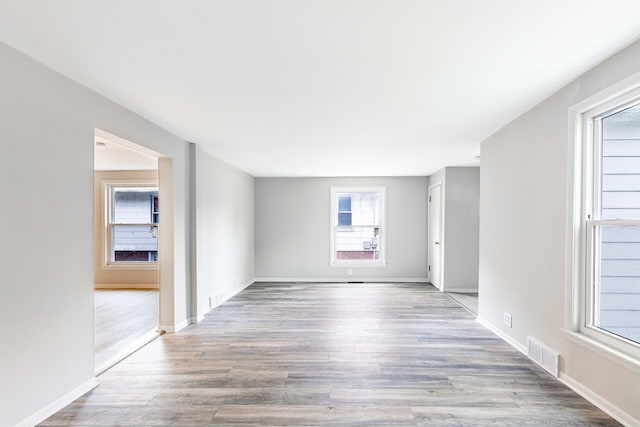 empty room featuring light hardwood / wood-style floors and a healthy amount of sunlight