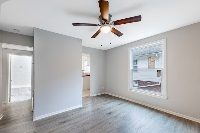 spare room with ceiling fan and light hardwood / wood-style flooring