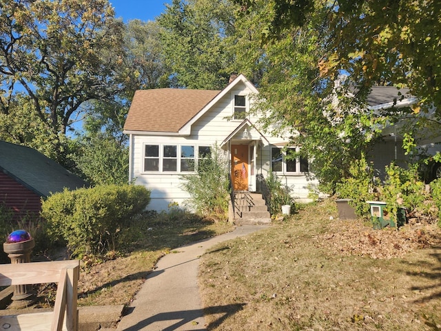 view of front of house featuring roof with shingles and a chimney