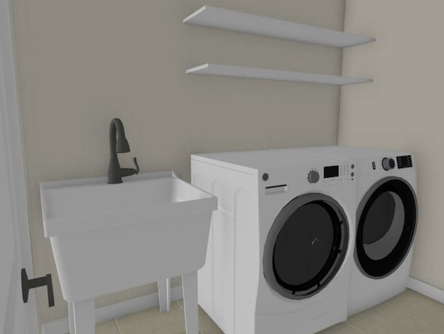 clothes washing area featuring sink, washing machine and clothes dryer, and light tile patterned floors