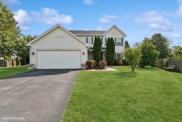 view of front of house featuring a front yard and a garage