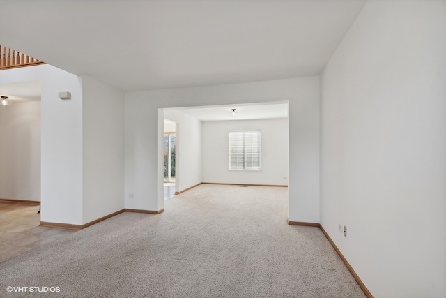 spare room featuring light colored carpet