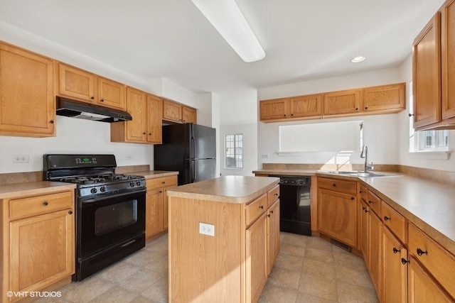 kitchen with sink, black appliances, a center island, and plenty of natural light