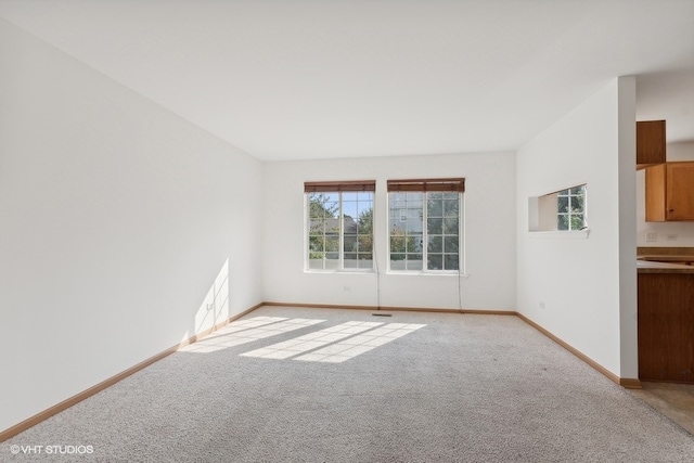 unfurnished room featuring light colored carpet