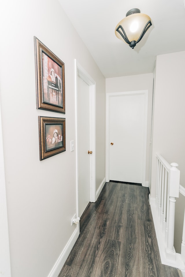 corridor with dark hardwood / wood-style flooring