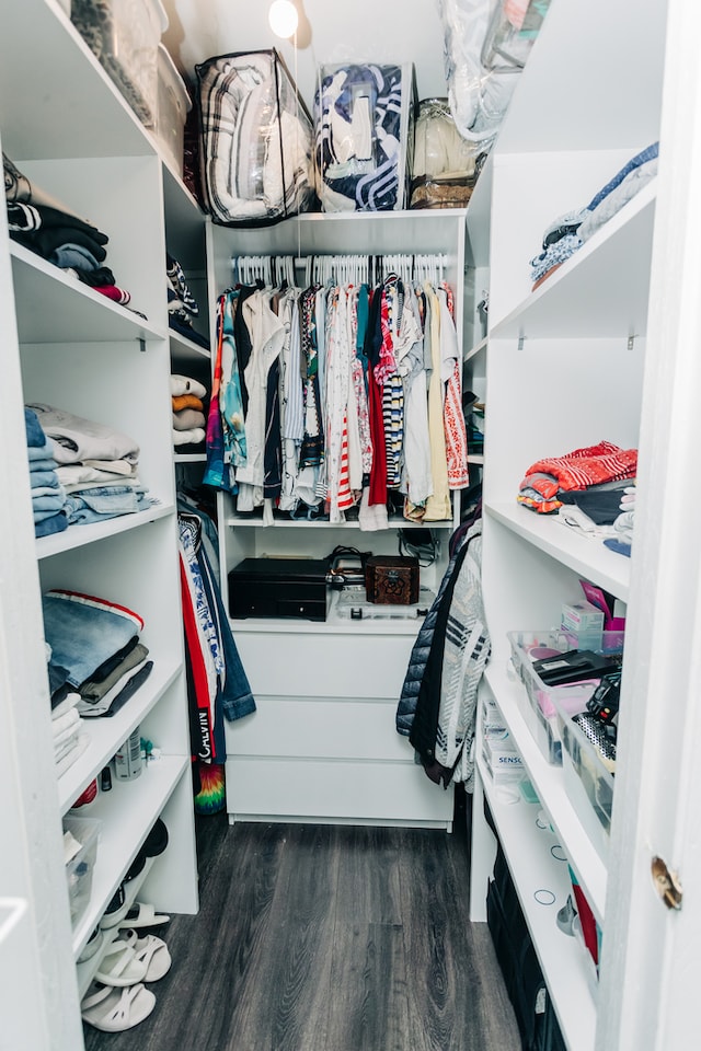 walk in closet with dark wood-type flooring