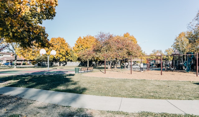 view of property's community with a playground, a yard, and basketball court