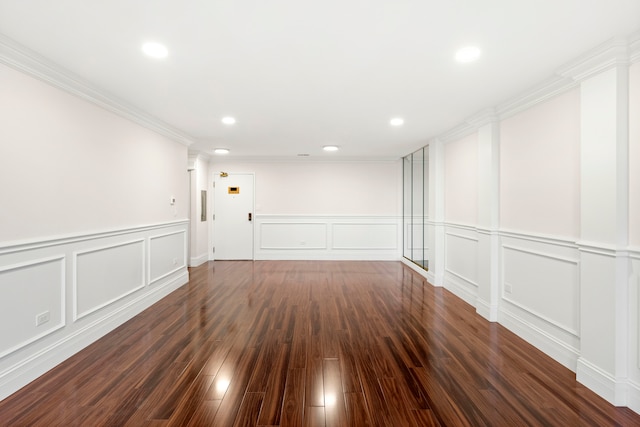 unfurnished room featuring crown molding and dark hardwood / wood-style flooring