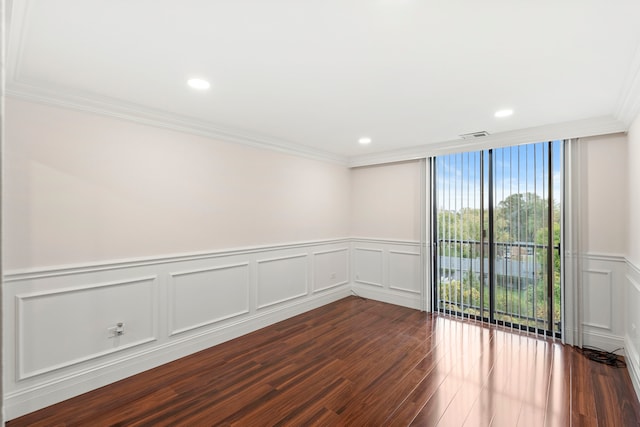 unfurnished room featuring ornamental molding and dark hardwood / wood-style floors