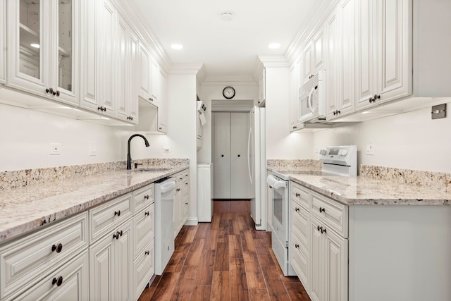 kitchen featuring white appliances, sink, dark hardwood / wood-style flooring, white cabinets, and ornamental molding