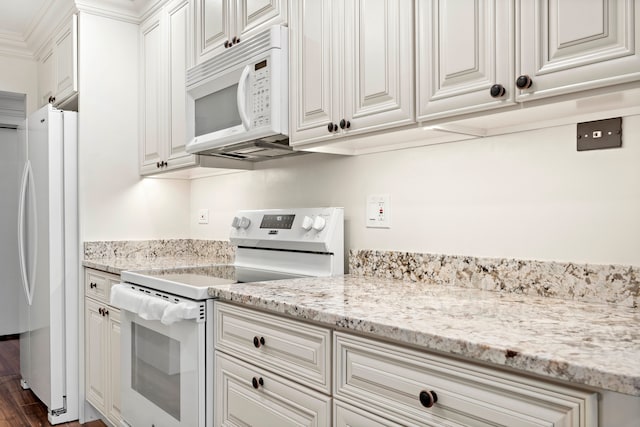 kitchen featuring white appliances, light stone counters, white cabinetry, and dark hardwood / wood-style flooring