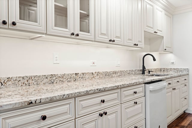 kitchen with sink, dishwasher, dark hardwood / wood-style flooring, white cabinets, and crown molding