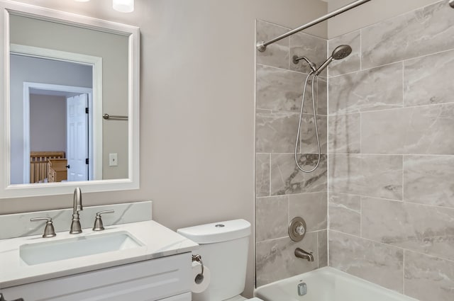 full bathroom with vanity, toilet, and tiled shower / bath