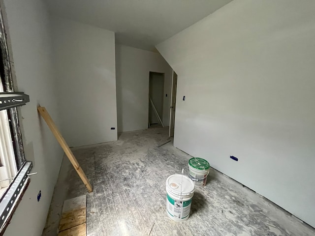 empty room featuring lofted ceiling