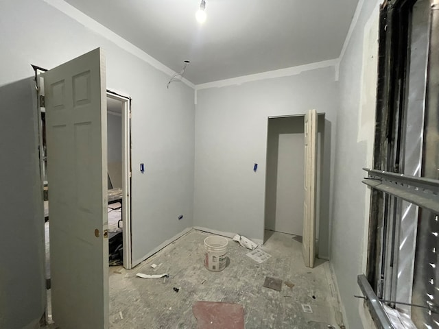 unfurnished room with crown molding