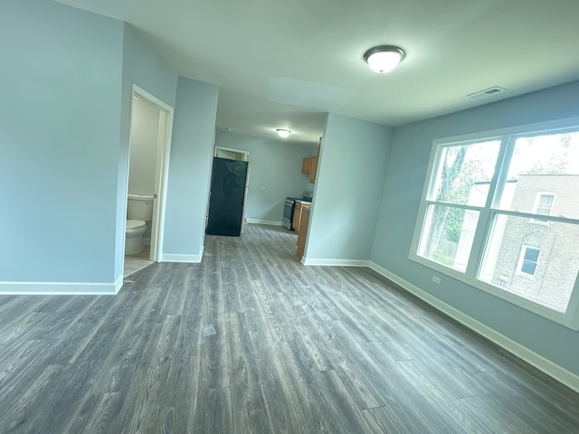 unfurnished living room with dark wood-type flooring