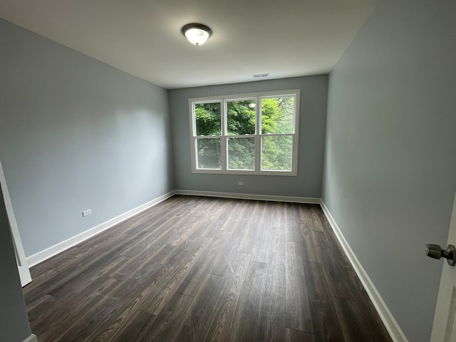 spare room featuring dark hardwood / wood-style floors