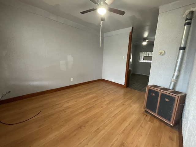 empty room with hardwood / wood-style floors and ceiling fan