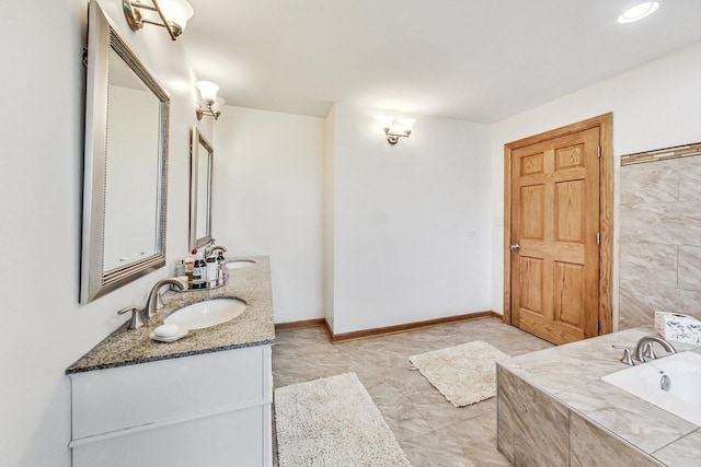 bathroom featuring vanity and a tub to relax in
