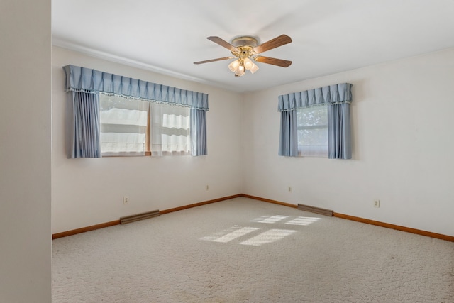 spare room featuring carpet and ceiling fan