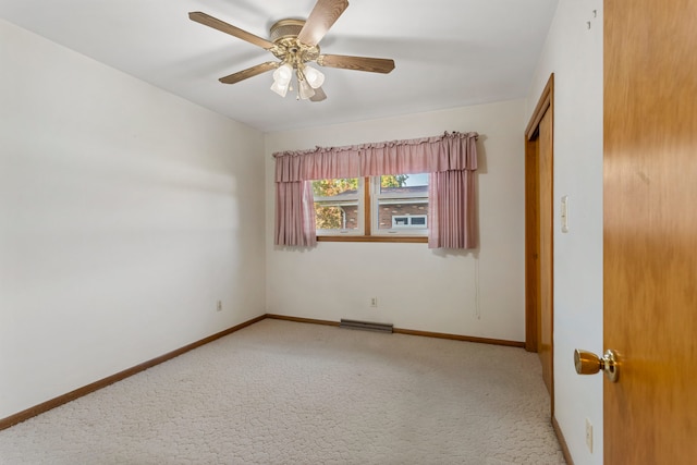 unfurnished room featuring light colored carpet and ceiling fan