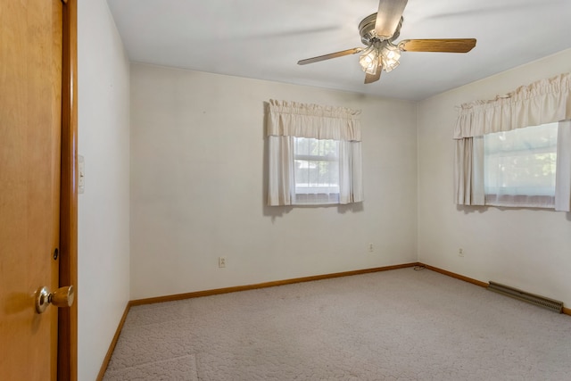 carpeted empty room featuring ceiling fan