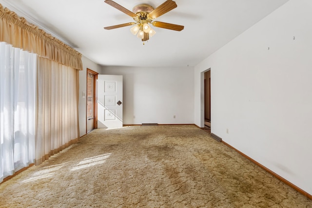 carpeted spare room with ceiling fan