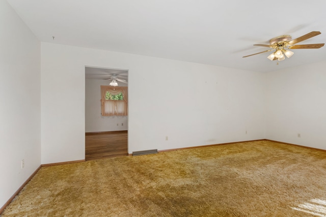 spare room with ceiling fan and carpet floors