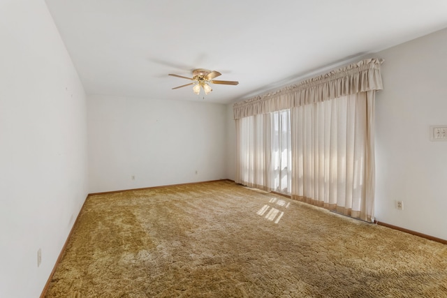 spare room featuring ceiling fan and carpet