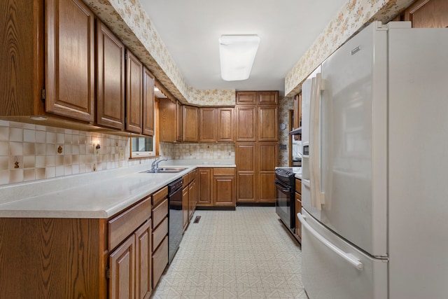 kitchen with sink, black appliances, and decorative backsplash