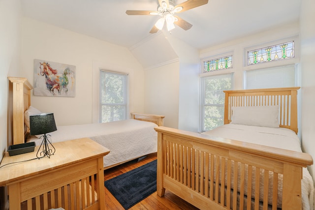 bedroom with lofted ceiling, hardwood / wood-style floors, and ceiling fan