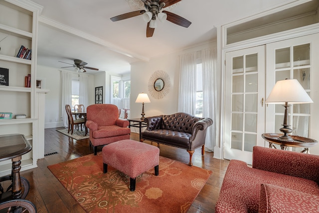 living room featuring ornamental molding, ceiling fan, built in features, and dark hardwood / wood-style flooring