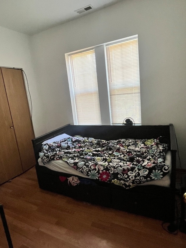 bedroom with hardwood / wood-style floors