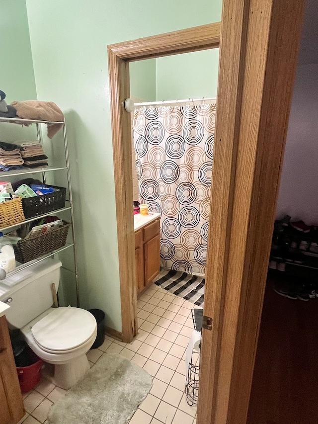 bathroom with vanity, toilet, and tile patterned floors