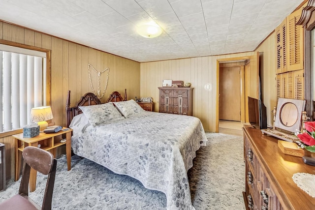 carpeted bedroom with wooden walls