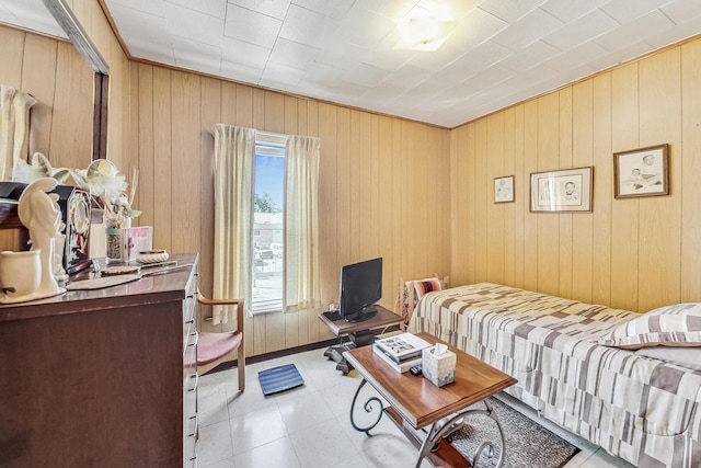 bedroom featuring wood walls