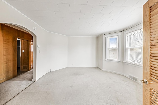 carpeted spare room featuring ornamental molding