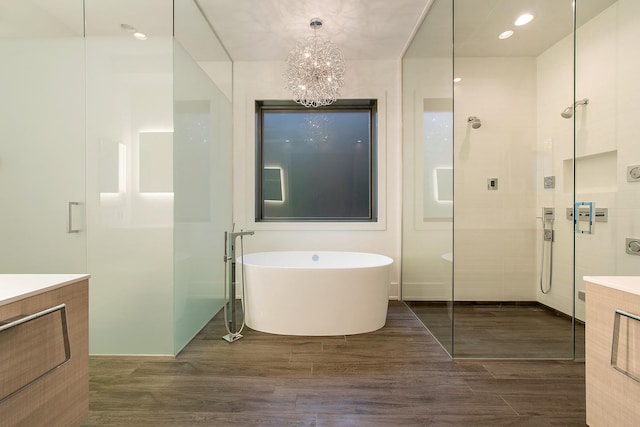 2118 N Clifton Ave, Chicago, IL 60614 - full bath featuring a freestanding bath, a tile shower, wood finished floors, vanity, and a chandelier