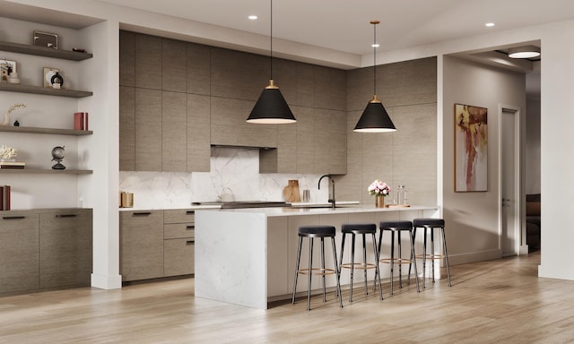 2118 N Clifton Ave, Chicago, IL 60614 - kitchen with a sink, light countertops, a kitchen breakfast bar, light wood-style flooring, and modern cabinets