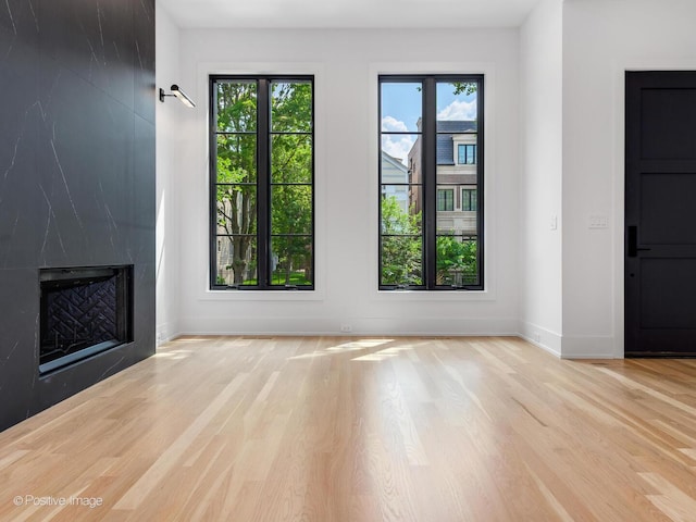2118 N Clifton Ave, Chicago, IL 60614 - unfurnished living room featuring a premium fireplace, baseboards, and wood finished floors
