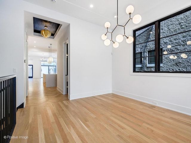 2118 N Clifton Ave, Chicago, IL 60614 - unfurnished dining area featuring light wood-style floors, a sink, baseboards, and a chandelier