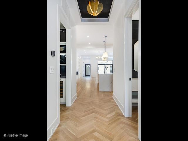 2118 N Clifton Ave, Chicago, IL 60614 - hallway featuring visible vents, baseboards, a raised ceiling, a notable chandelier, and recessed lighting