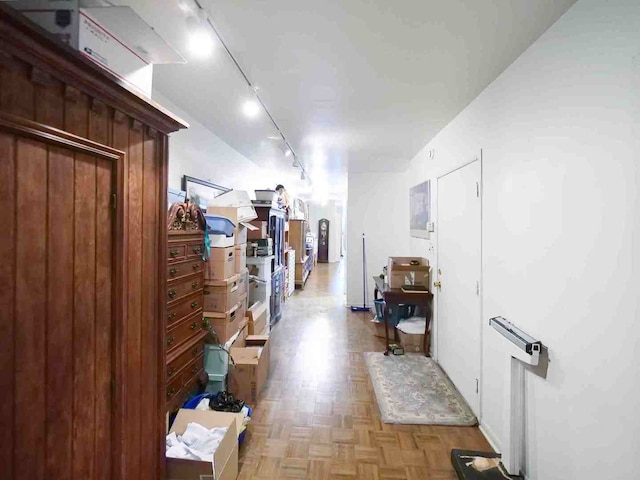 corridor with track lighting and light parquet floors